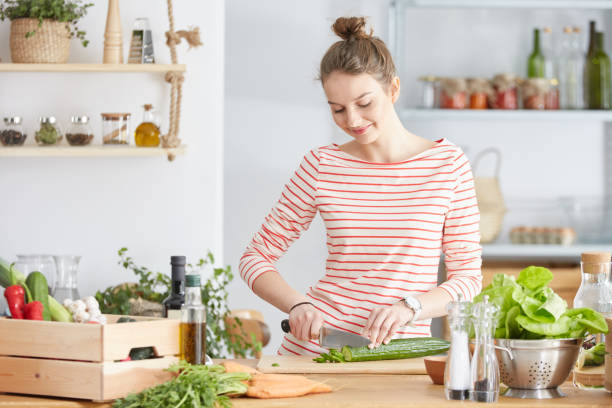 istock Woman cutting a cucumber 691789884