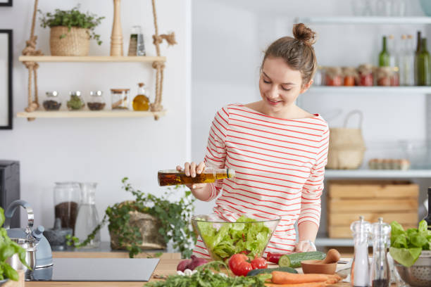 istock Woman adding olive to a salad 691789924