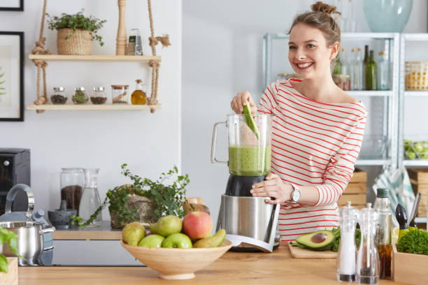 istock Woman preparing green smothie 691789948