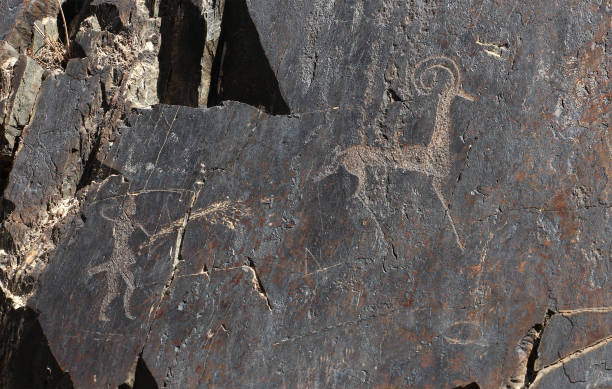 istock ancient rock drawings, deer and human with the spear, hunting 691793376