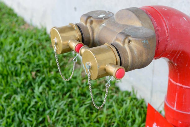 Fire hydrant manifold two outlet water valve. Fire department connection Fire hydrant manifold two outlet water valve. Fire department connection environmental pressure oven photos stock pictures, royalty-free photos & images