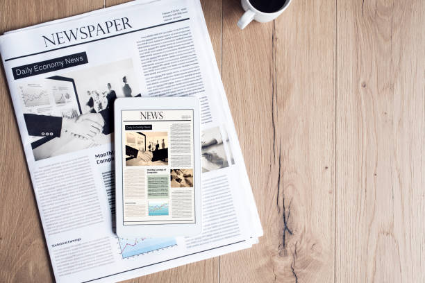 istock Newspaper with tablet on wooden table 691796746