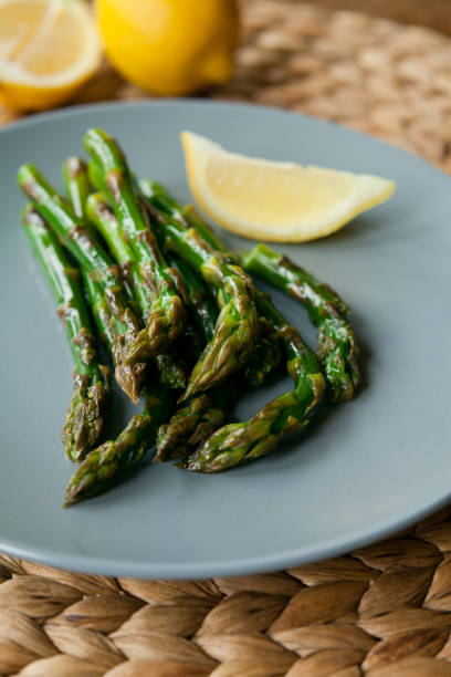 istock Thin green asparagus roasted  in  lemon sauce. 691796750