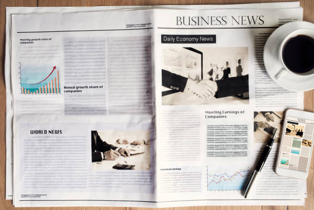 istock Newspaper on wooden table 691796760