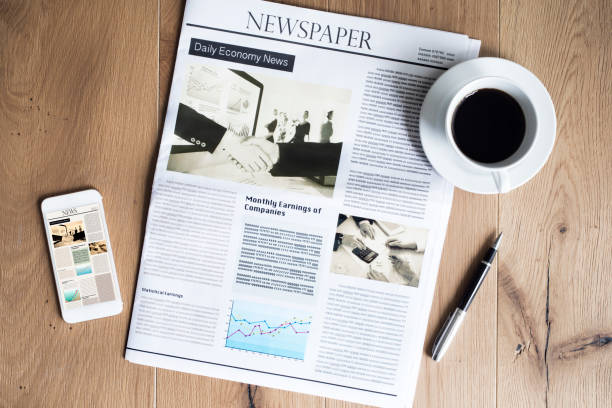 istock Newspaper on wooden table 691796784
