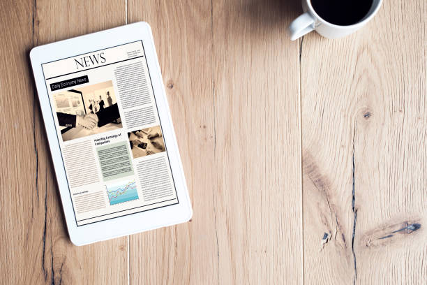 istock Newspaper on digital tablet on wooden table 691796844