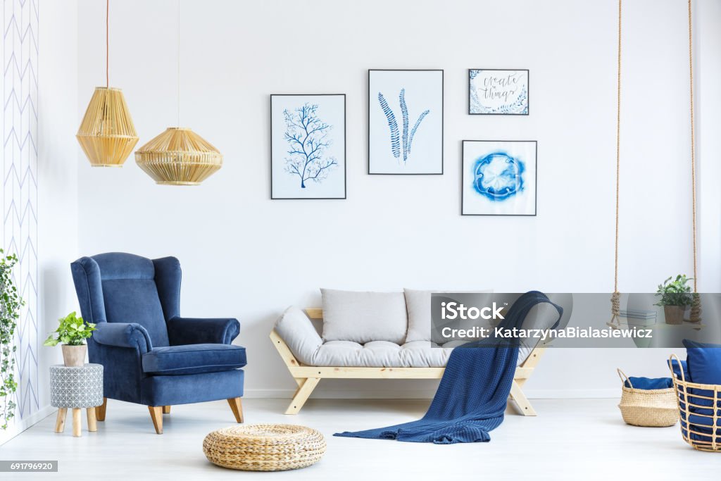 White and blue living room White and blue living room with sofa, armchair, lamp, posters Blue Stock Photo