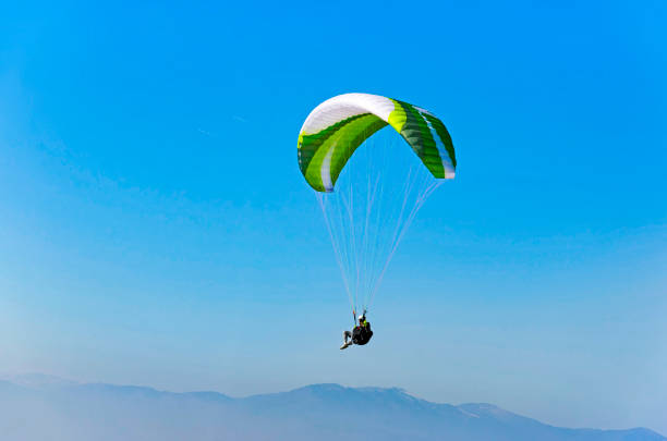 istock Sepia paraglide silhouette over Alps peaks 691799656