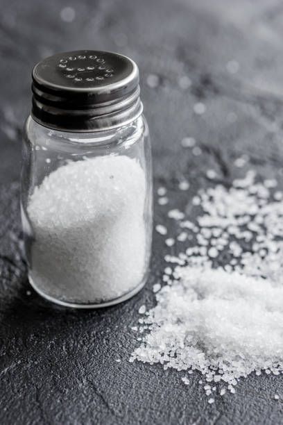 istock salt in glass saltcellar on black stone table background 691801572