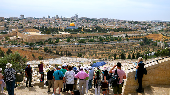 Jerusalem - May 24, 2017: The guide shows the Jerusalem Old City view to the tourists. Mount of Olives is a famous and sacred Christian's place and it has a fantastic view to the Old Jerusalem.