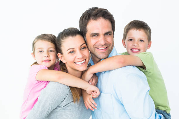 istock Happy young family looking at camera together 691808776
