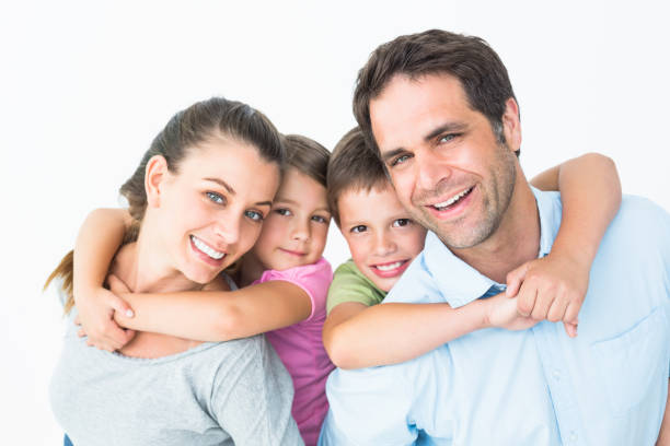 istock Smiling young family looking at camera together 691810476