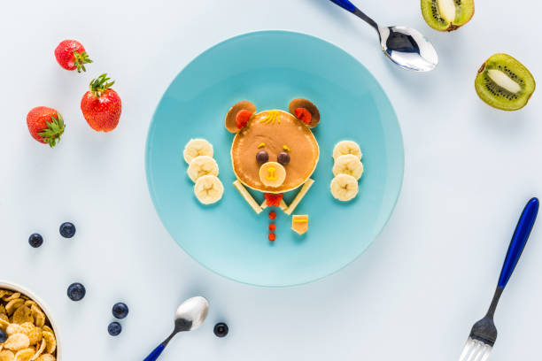 istock flat lay with creatively styled children's breakfast with berries and kiwi 691811056