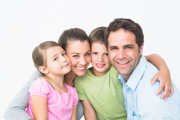 istock Cute family smiling at camera together 691811068