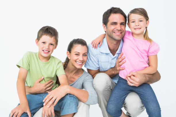 istock Cute family posing and smiling at camera together 691811188
