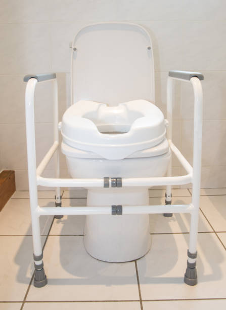 Toilet with raised seat to assist infirm or recovering patients stock photo