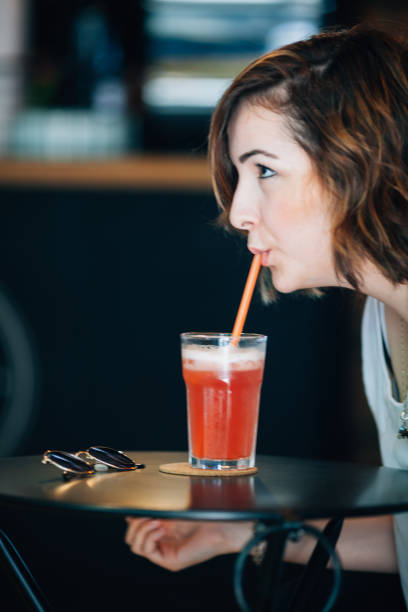 istock Woman drinking strawberry lemonade 691812282