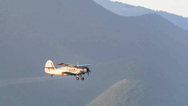 istock Crop duster spraying crops from the air in the morning light while turning to make another spraying run 691812294