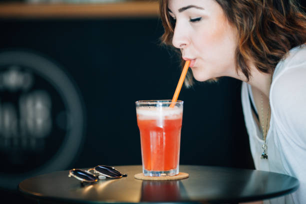 istock Woman drinking strawberry lemonade 691812318