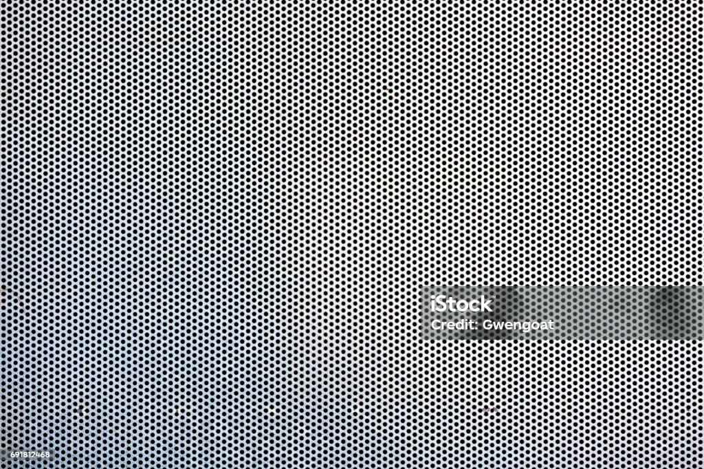 Metal plate with round holes Seamless hexagon perforated metal grill pattern. Metal Stock Photo