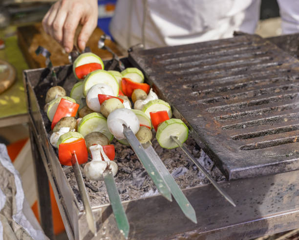 istock Cooking vegetables and mushrooms on grill skewers 691815480