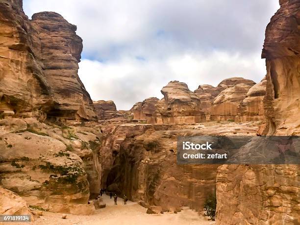 The Siq The Narrow Slotcanyon That Serves As The Entrance Passage To The Hidden City Of Petra Jordan Seen Here With Tourists Walkingthis Is An Unesco World Heritage Site Stock Photo - Download Image Now