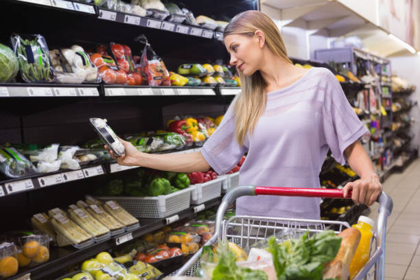 istock Smiling woman taking a vegetables in the aisle 691826222