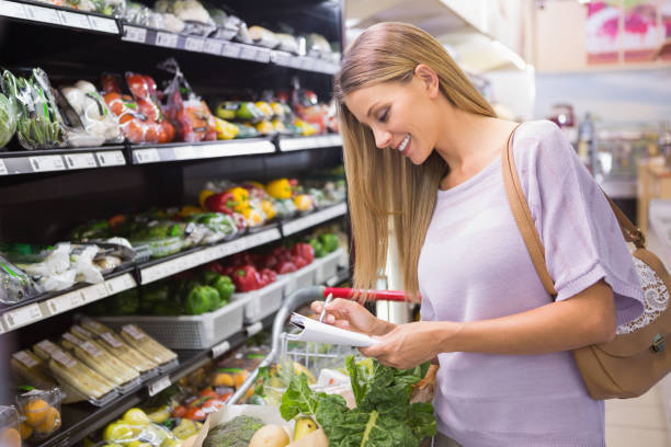 istock Smiling woman reading on his notepad in aisle 691826520