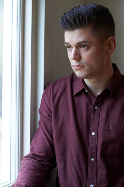 istock Sad Man Suffering From Depression Looking Out Of Window 691826768