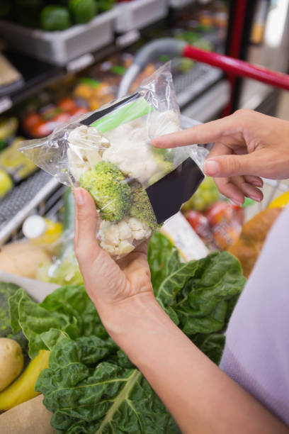 istock Woman hands pointing at broccolis 691828934