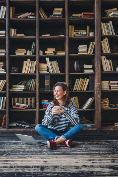 istock Young woman studying in the library 691829304