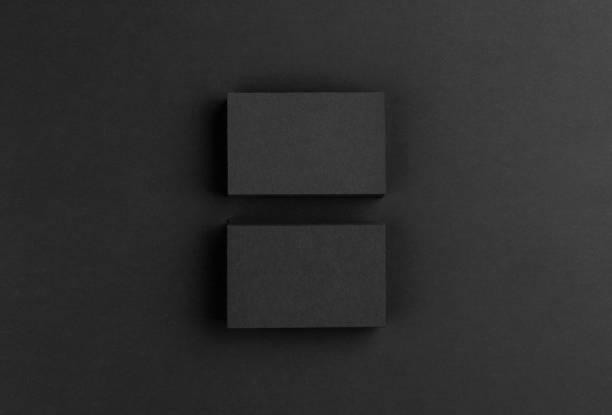 istock Black business cards isolated on black background 691832438