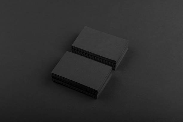 istock Black business cards isolated on black background 691832448