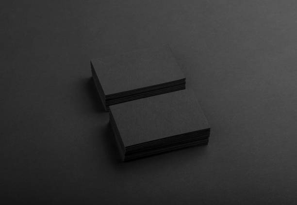 istock Black business cards isolated on black background 691832464