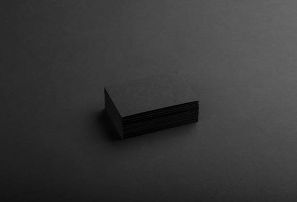 istock Black business cards isolated on black background 691832488