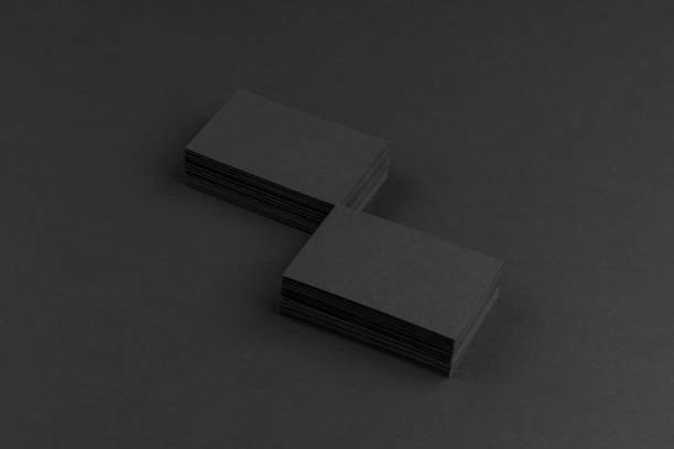 istock Black business cards isolated on black background 691832530