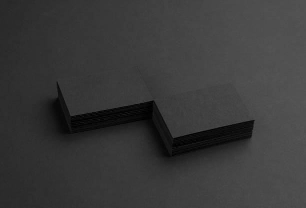 istock Black business cards isolated on black background 691832532