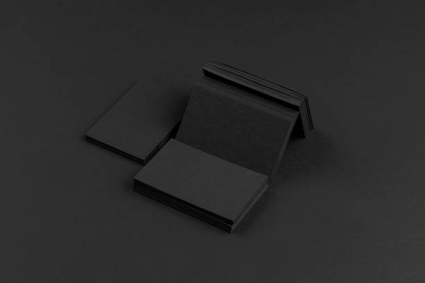 istock Black business cards isolated on black background 691832614