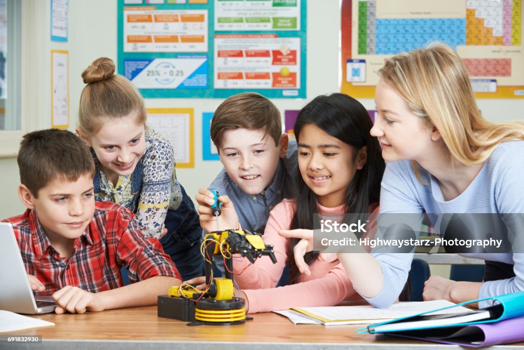 Pupils And Teacher In Science Lesson Studying Robotics Junior High Student Stock Photo