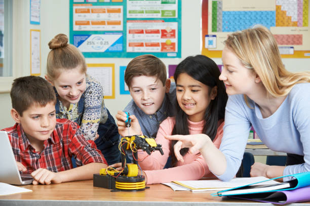 pupils and teacher in science lesson studying robotics - teacher computer high school student classroom imagens e fotografias de stock