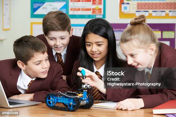 School Pupils In Science Lesson Studying Robotics Stock Photo - Download Image Now - Uniform, Science, School Children