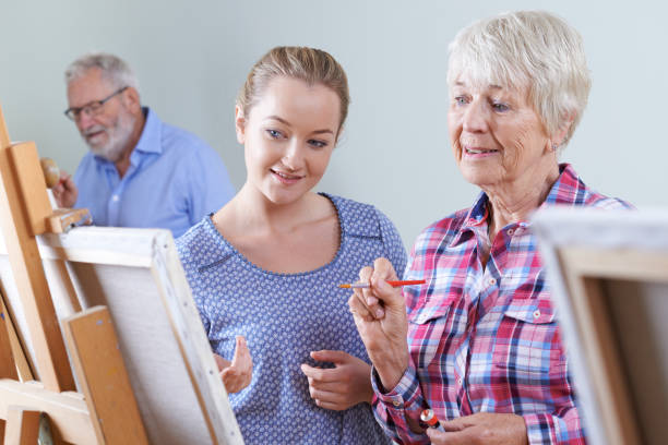 istock Seniors Attending Painting Class With Teacher 691839594