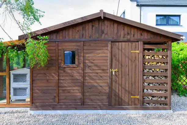Garden shed exterior in Spring, with woodshed