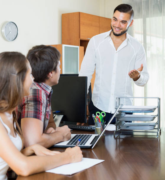 istock Married couple signing contract  in the office 691843136