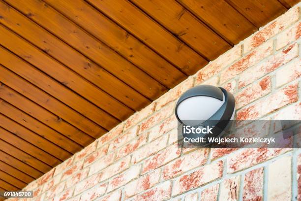 Modern Wall Lamp With Motion And Light Sensor On The Brick Wall Stock Photo - Download Image Now