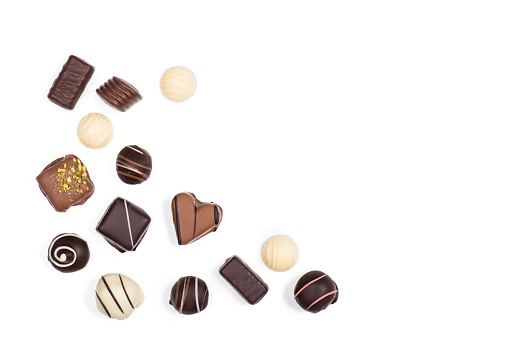Flat lay of assortment of sweet delicious chocolate candies isolated on white