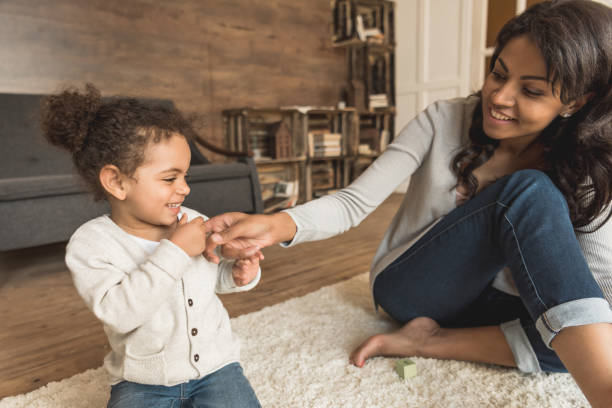 istock mother playing with little daughter while spending time at home 691848188