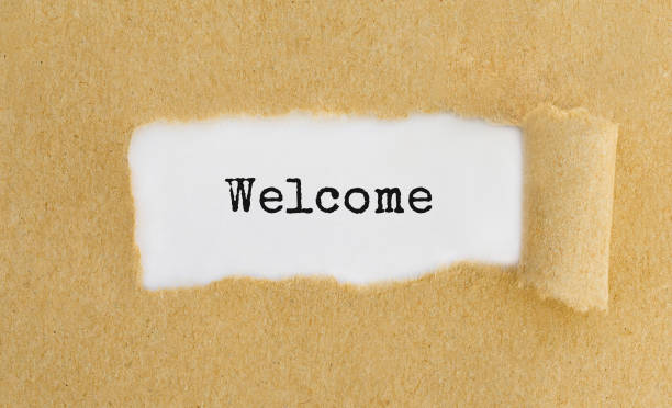 istock Text Welcome appearing behind ripped brown paper 691848314