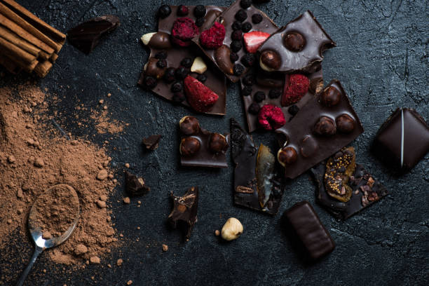 istock pieces of chocolate bar with nuts and berries with cinnamon and spoon 691852584