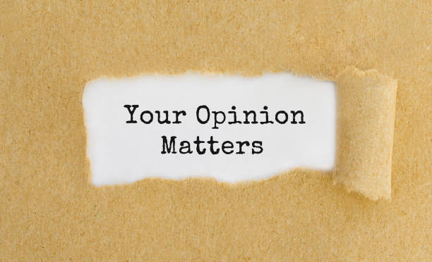 istock Text Your Opinion Matters appearing behind ripped brown paper 691853400